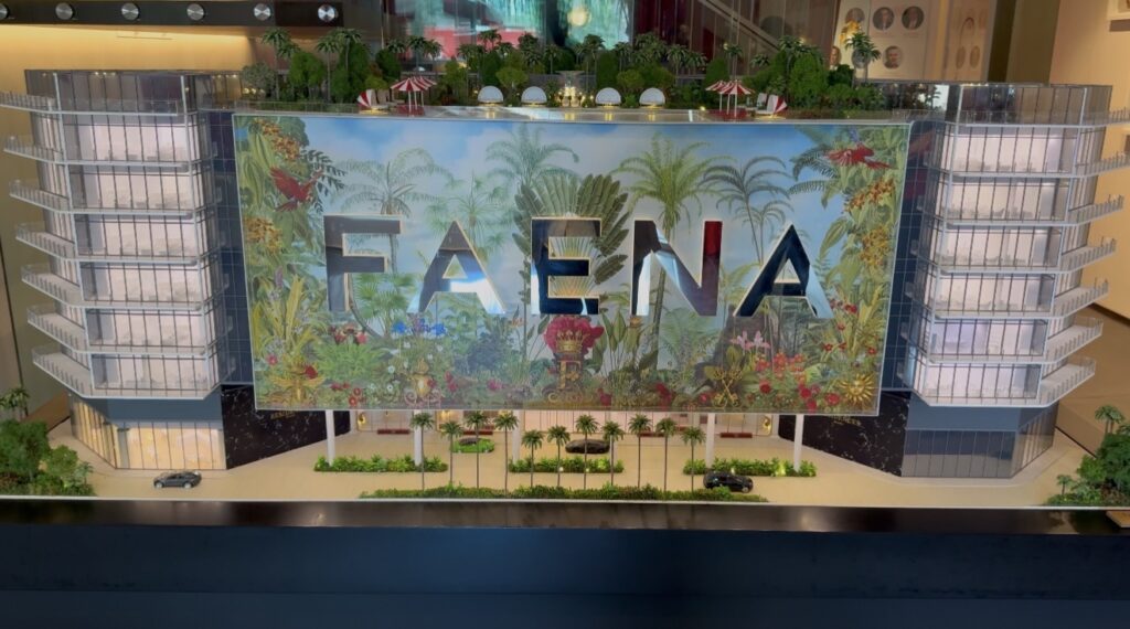 Architectural model of the Faena development displayed inside a Miami sales gallery, featuring a colorful tropical design.