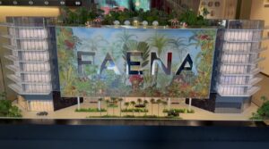 Architectural model of the Faena development displayed inside a Miami sales gallery, featuring a colorful tropical design.