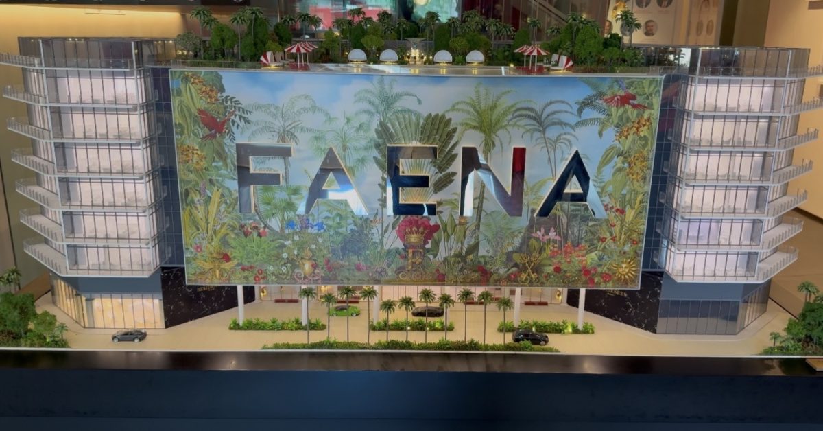 Architectural model of the Faena development displayed inside a Miami sales gallery, featuring a colorful tropical design.